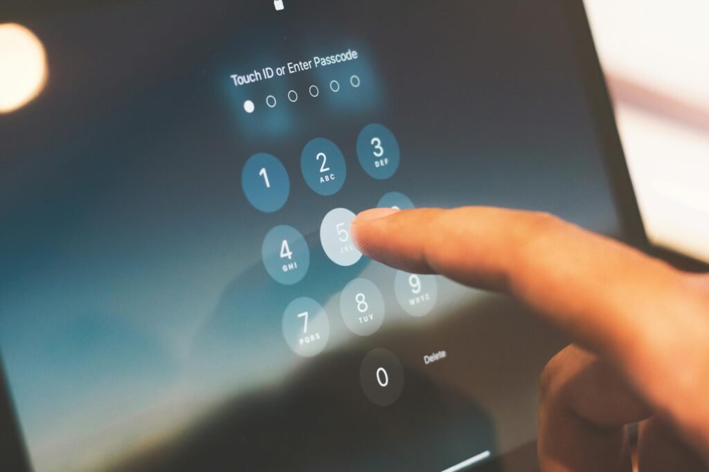 A finger tapping a number on a smartphone passcode screen for privacy access