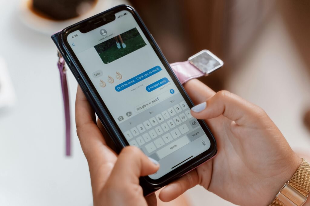 A person using a smartphone keyboard app while typing a message.